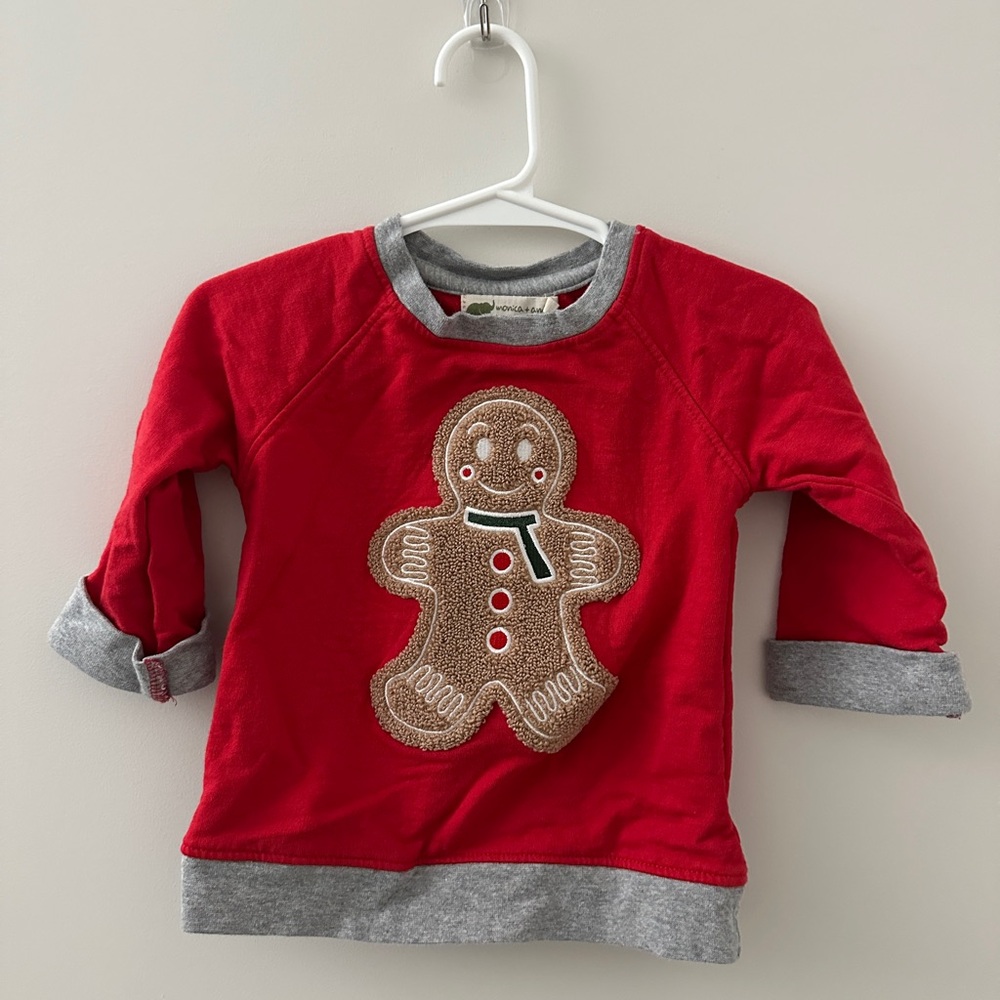 Festive red baby sweater with gingerbread design